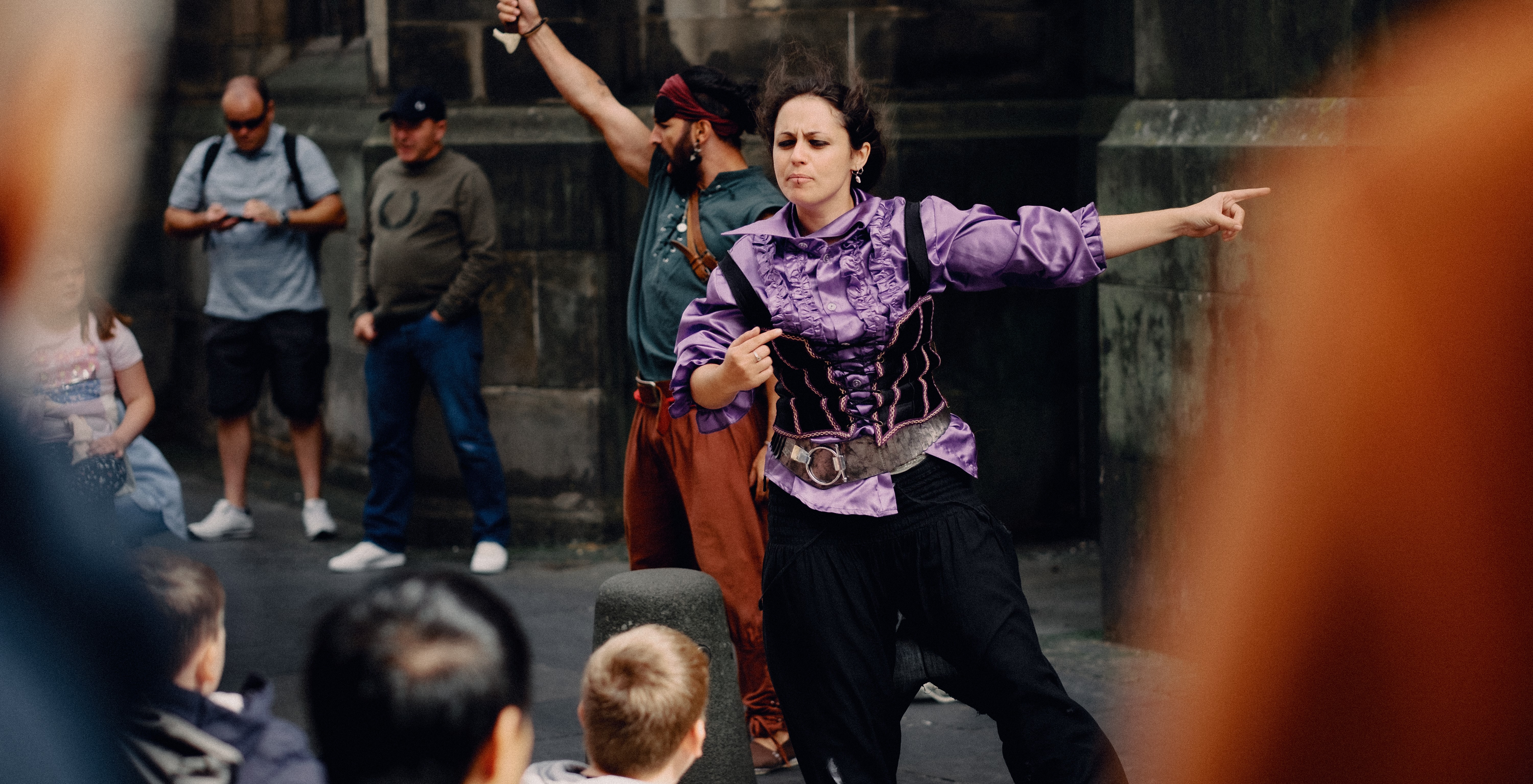Photo shows man and women dressed as pirates while children watch on Edinburgh's Royal Mile
