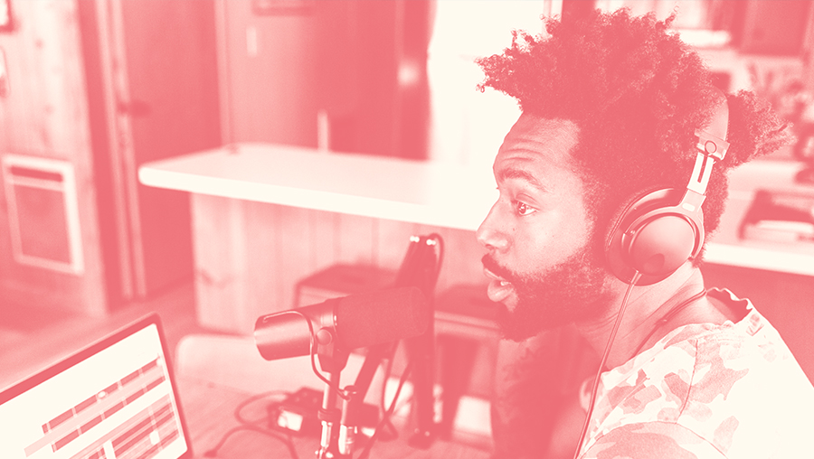 photo shows man in home studio, the photo has a red overlay