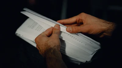 Hands holding document