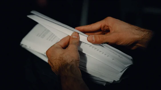 Hands holding document