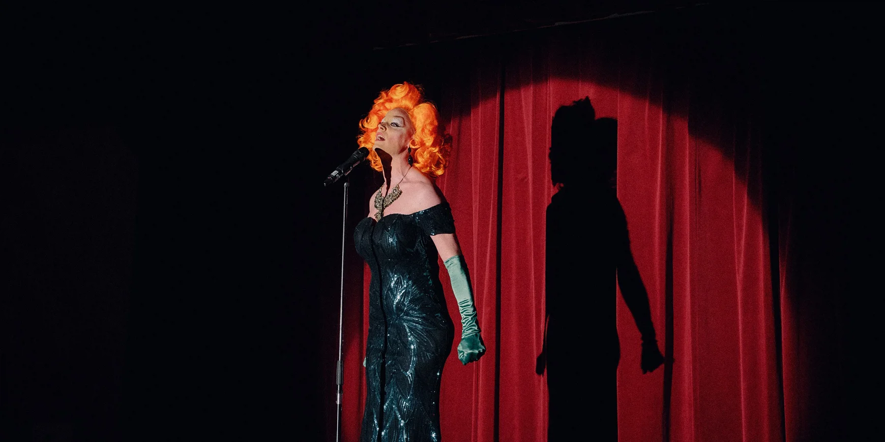 Decorative image: Drag queen singing on stage