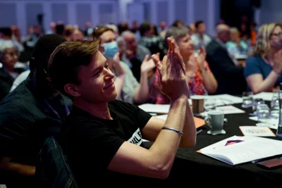 Photo shows man in foreground at Equity conference 2022