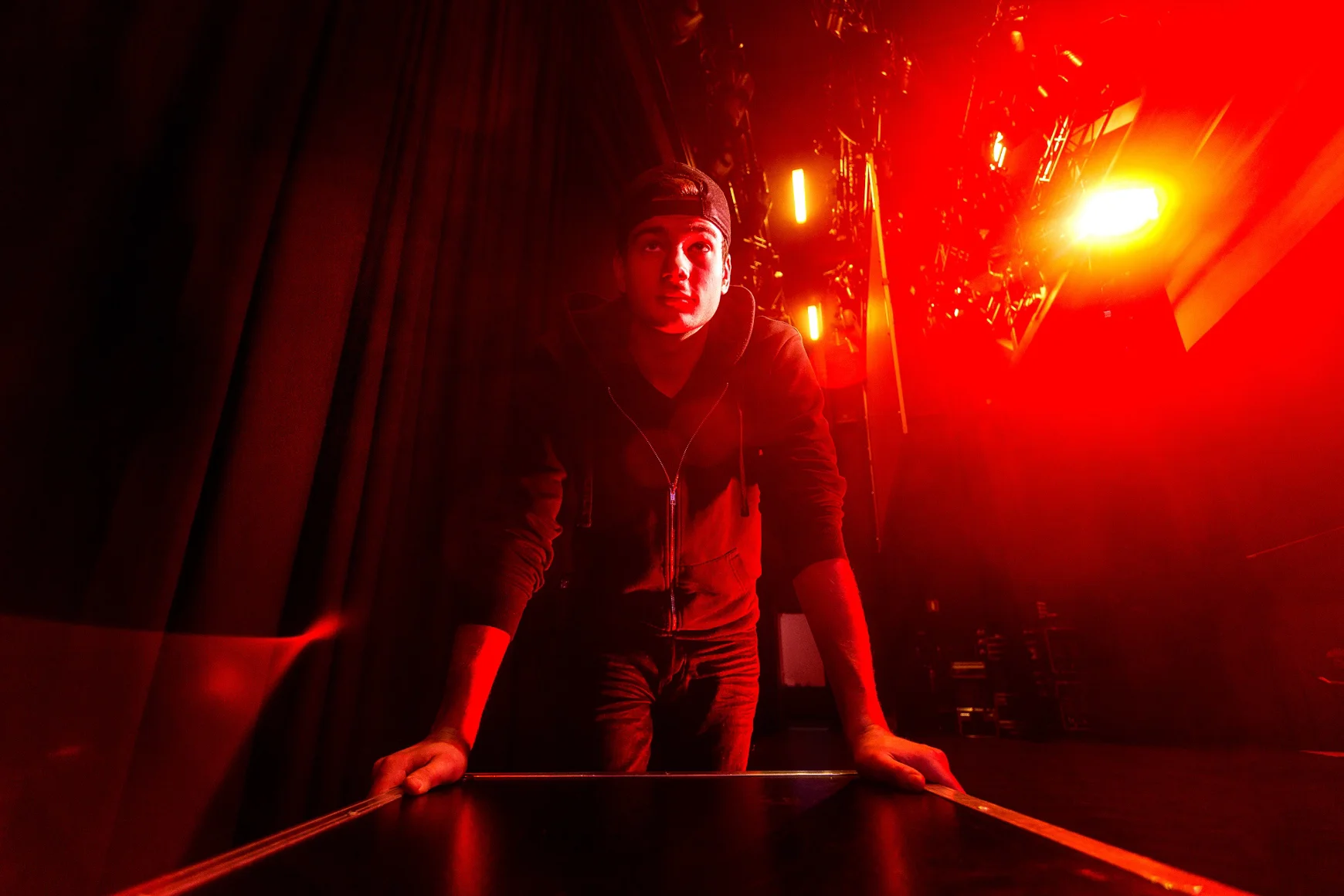 Crew backstage pushing a box