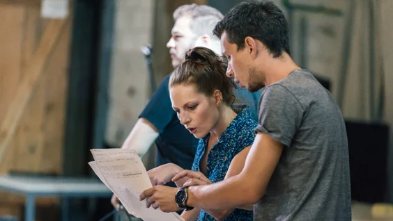 Man and woman reading script together