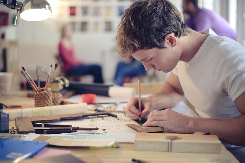 Person at desk drawing