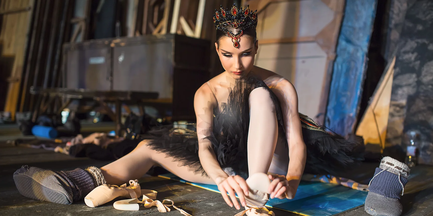 Ballet dancer putting on ballet shoes