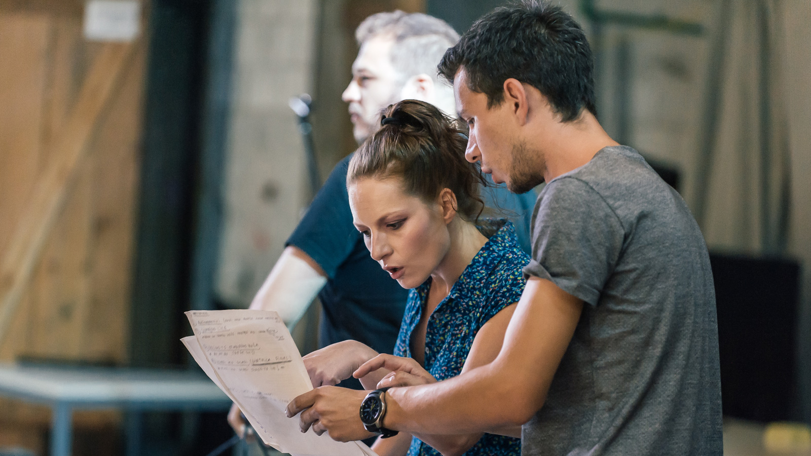 Actors rehearse with script