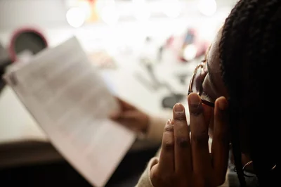 Woman reading a script in dressing room