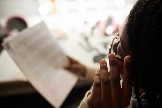 Woman reading a script in dressing room