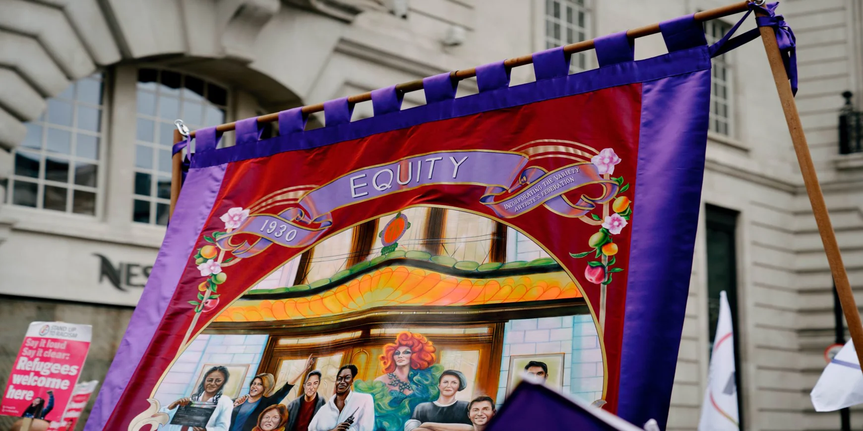 a photo of an equity banner being flown during industrial action