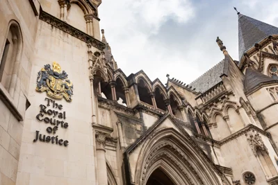 Photo shows close up of Royal Courts of Justice emblem on court building which is in gothic revival style