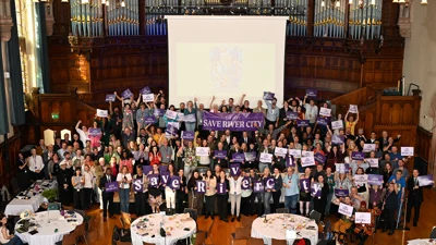 Members at Equity conference hold Save River City signs. 