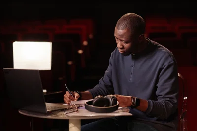 Man in theatre writing