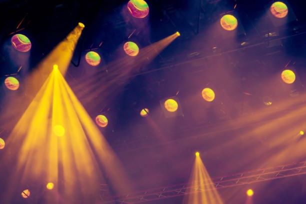 Photo shows overhead stage lights shining downwards