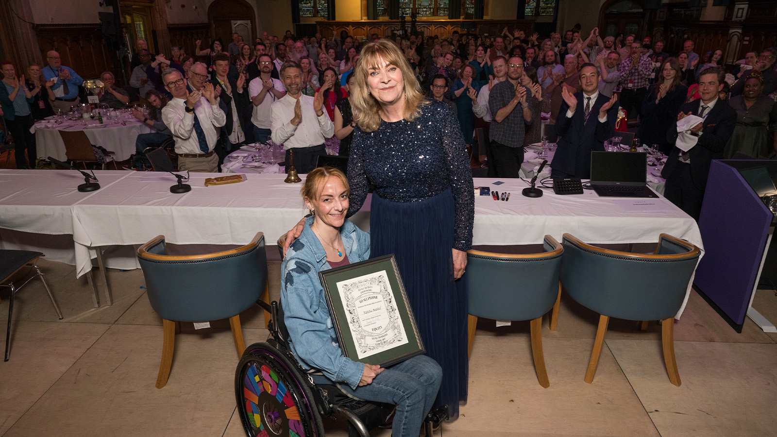 Natalie holding her certificate with Lynda Rooke next to her